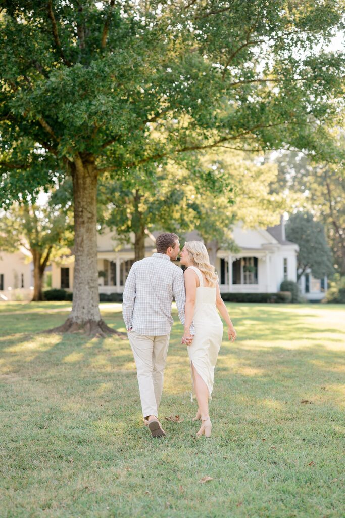 Madison MS engagement photo of couple holding hands at sunset